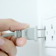 hand plugging into an outlet