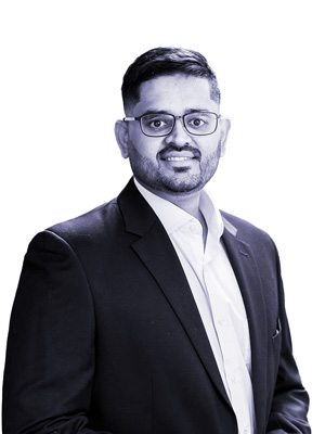 Khuram Zaidi Engagement Manager at Revenue Management Labs wearing glasses and a suit standing in front of a white background.